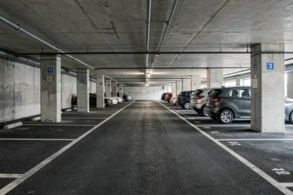 Parking souterrain avec des places de stationnement aux dimensions variées, illustrant la rentabilité locative selon la taille des espaces